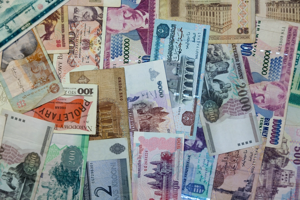 A pile of banknotes from many different countries